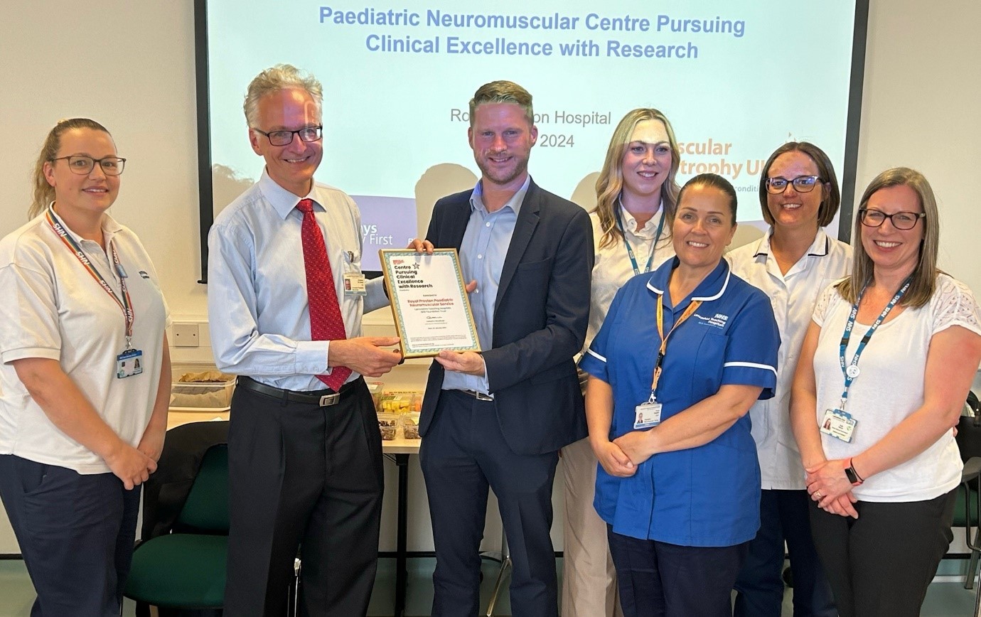 Group photo of team receiving award certificate