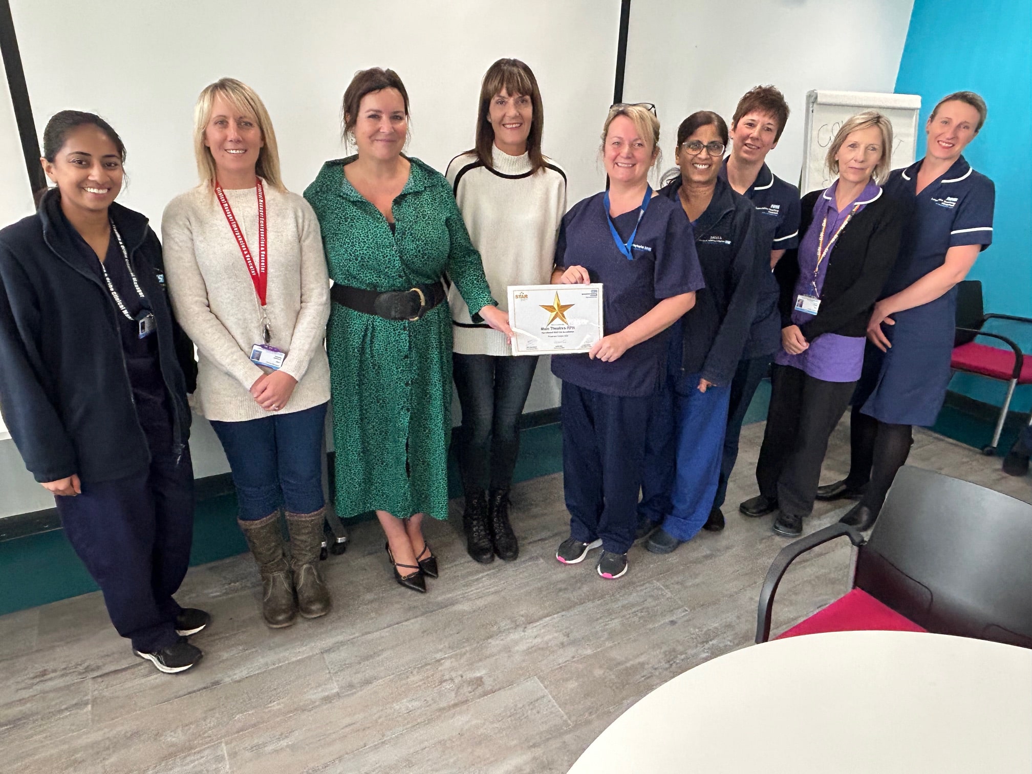 LTHTR staff members holding the award certificate, smiling