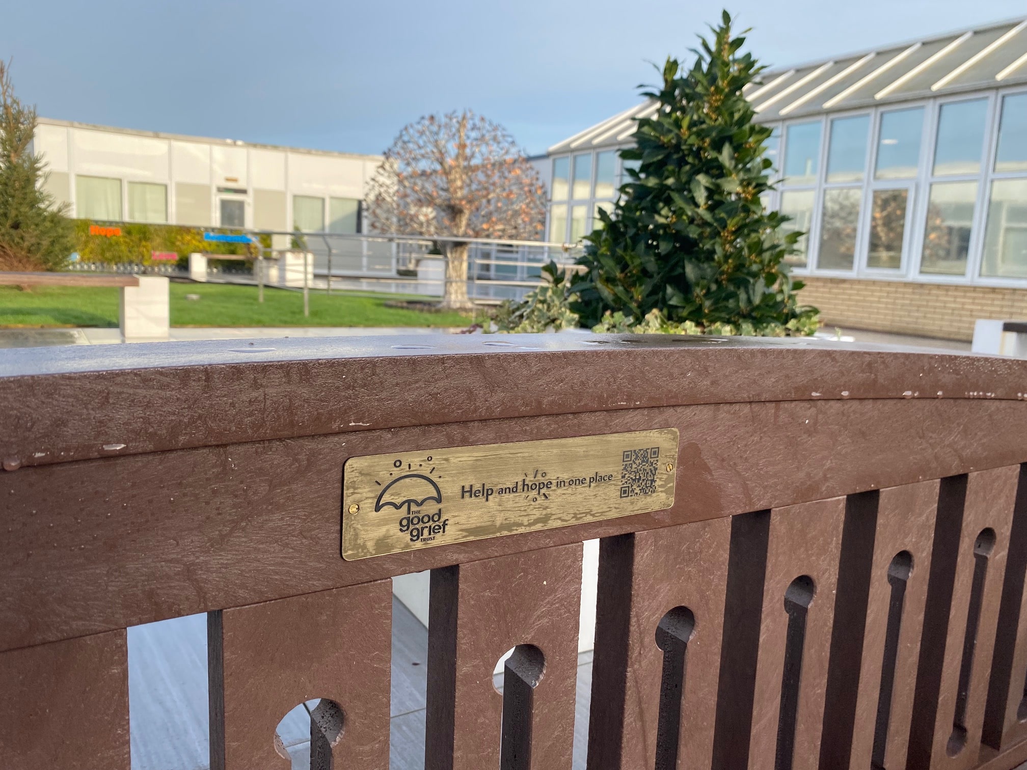 Photo of plaque on wooden fence