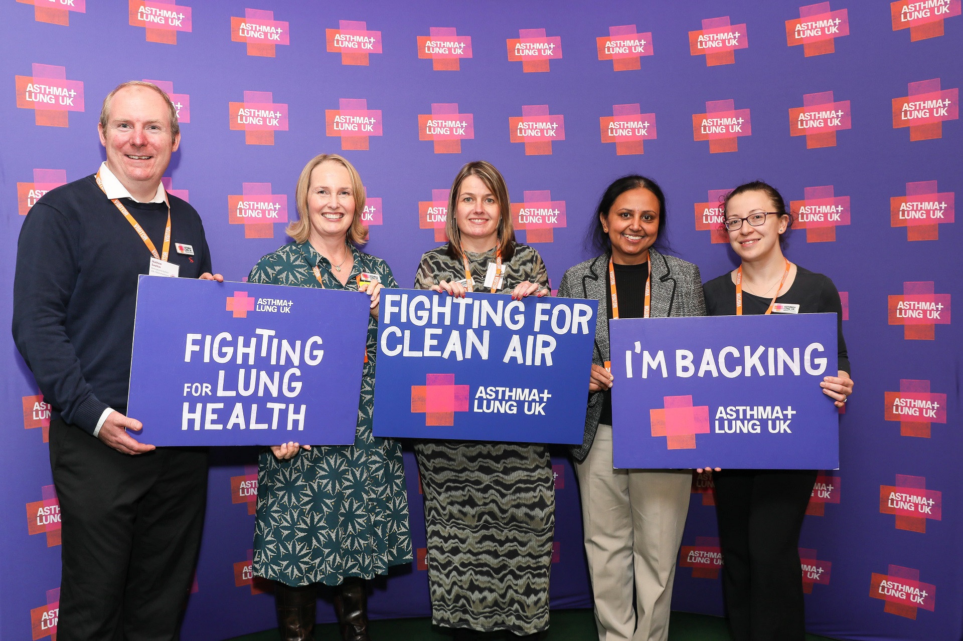 Group photo featuring Sharada Gudur and other professionals, all holding inspirational Asthma+ Lung UK signs, smiling, official photoshoot