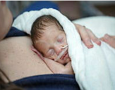 A baby lying on its mother's chest